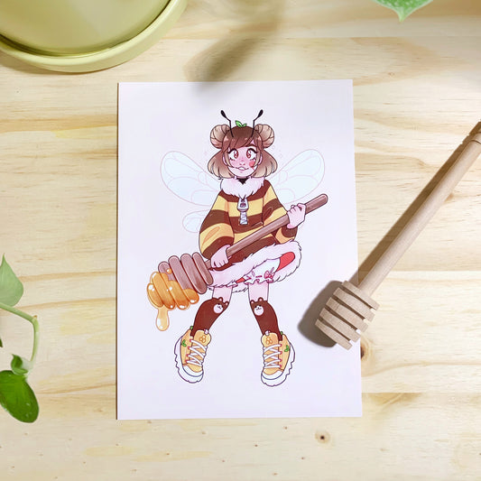 Printed illustration of a cute young girl wearing a fluffy bee striped dress, bee wings, bear knee high socks, yellow sneakers, with brown hair with space buns holding a large honey dipper covered in dripping honey. Photographed on a wooden background with a wooden honey dipper for decor.